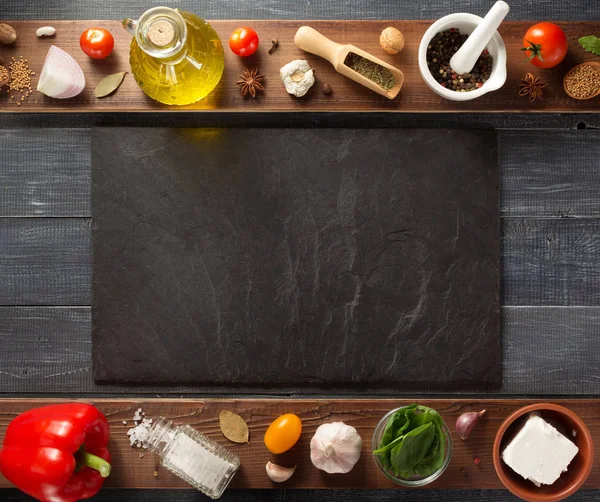 Spice, herbs and food ingredients on wood — Stock Photo, Image