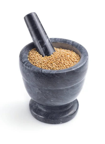 Mustard seeds in mortar on white — Stock Photo, Image