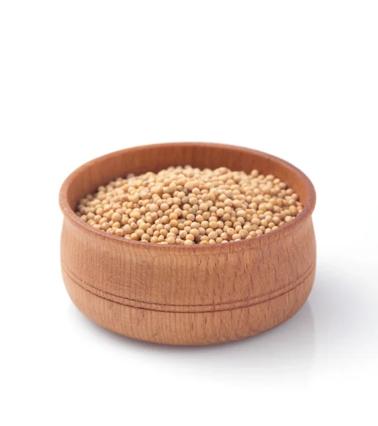 Mustard seeds in wooden bowl  on white — Stock Photo, Image