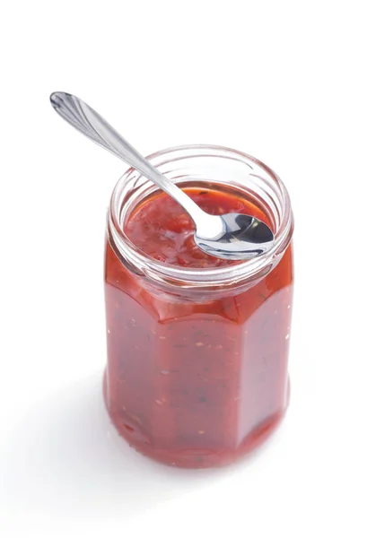 Tomato sauce in glass jar on white — Stock Photo, Image