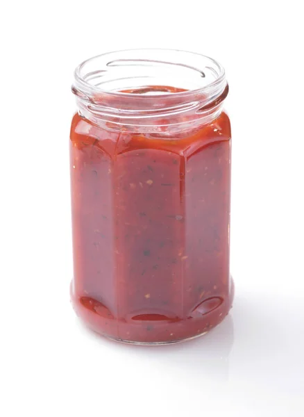 Tomato sauce in glass jar on white — Stock Photo, Image