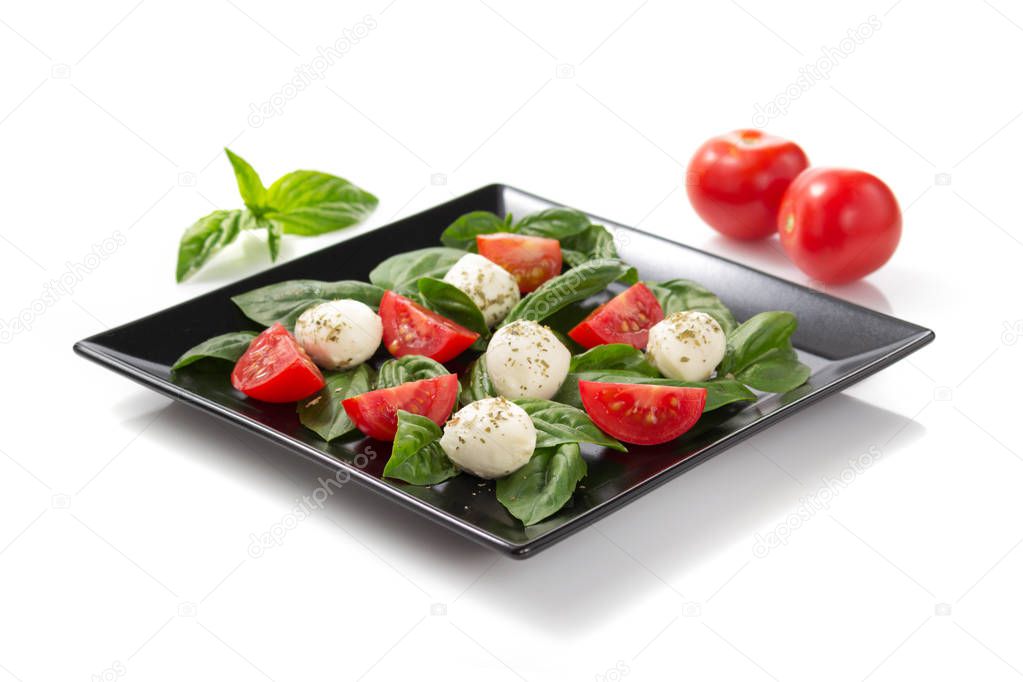 caprese salad in plate on white background
