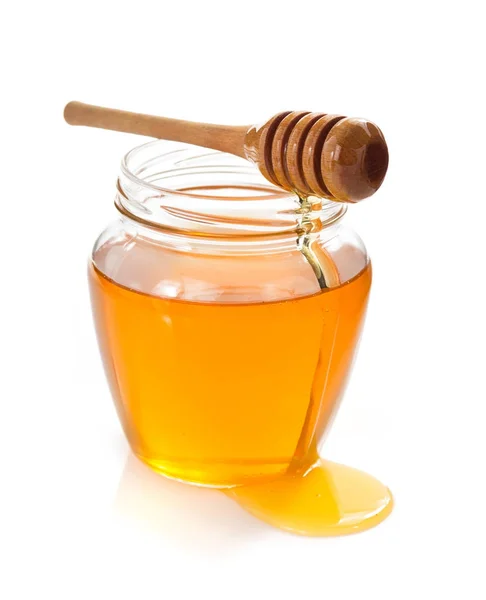 Glass jar full of honey and dipper — Stock Photo, Image