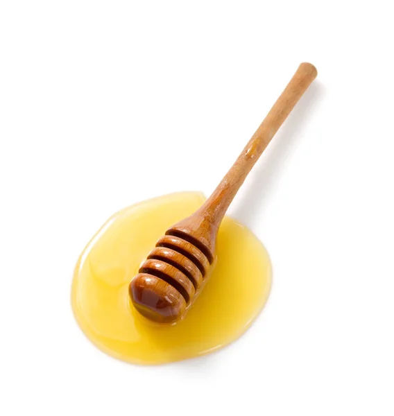 Honey and wooden dipper i on white — Stock Photo, Image