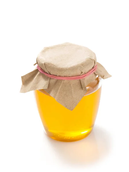 白い背景の上の蜂蜜のガラス瓶 — ストック写真