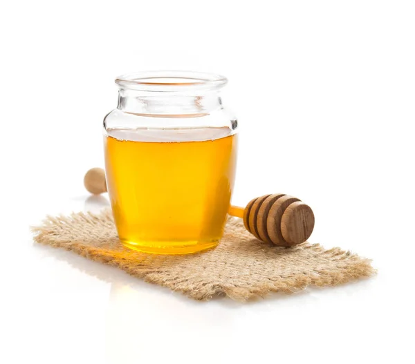 Tarro de miel sobre fondo blanco — Foto de Stock