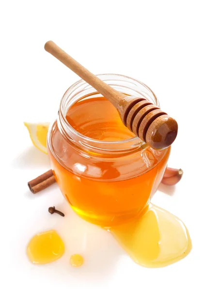 Glass jar full of honey and dipper — Stock Photo, Image