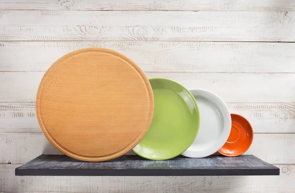 Plate at shelf on white wooden background — Stock Photo, Image