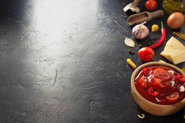 Tomato sauce in bowl on black background — Stock Photo, Image