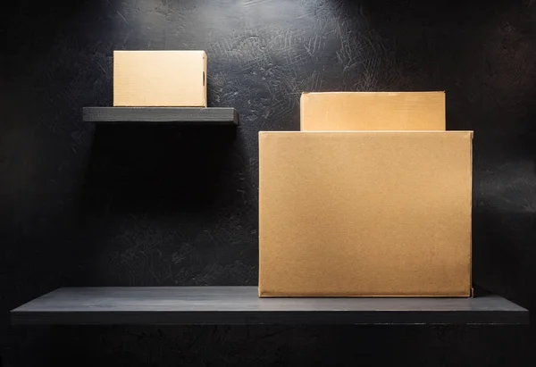 Kartonnen doos op houten plank — Stockfoto