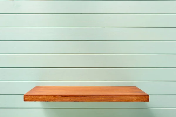Shelf at wooden background wall — Stock Photo, Image