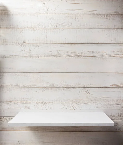 White shelf on wooden wall background — Stock Photo, Image