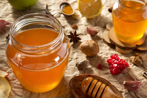 Glass jar of honey on paper — Stock Photo, Image