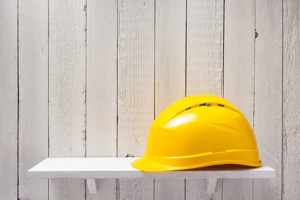 Construction helmet on shelf — Stock Photo, Image