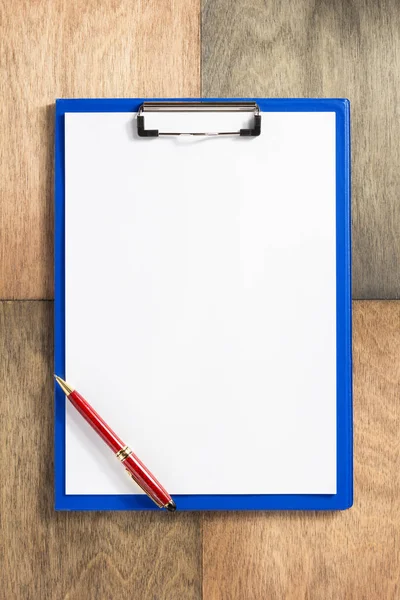 Paper clipboard at wooden background — Stock Photo, Image