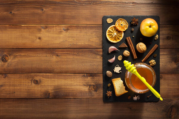 glass jar of honey on wood