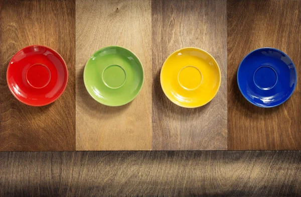 Empty saucer at wooden table — Stock Photo, Image