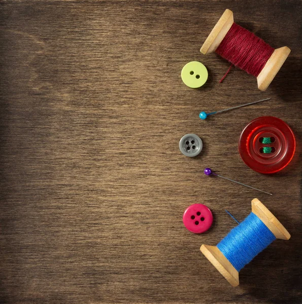 Sewing tools on wooden background — Stock Photo, Image