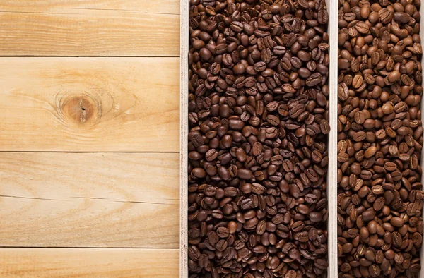 Coffee beans in wooden plank box — Stock Photo, Image