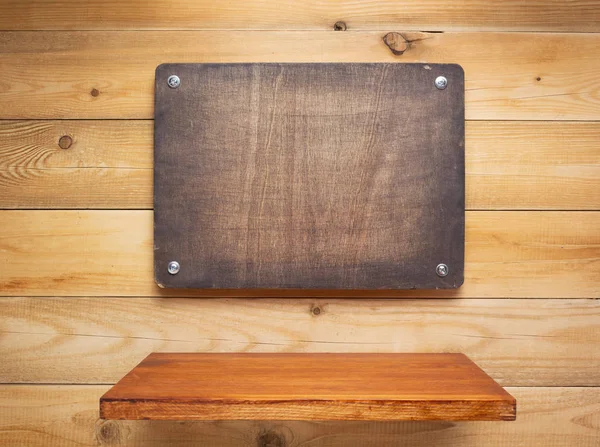 Wooden sign board and shelf at wall — ストック写真