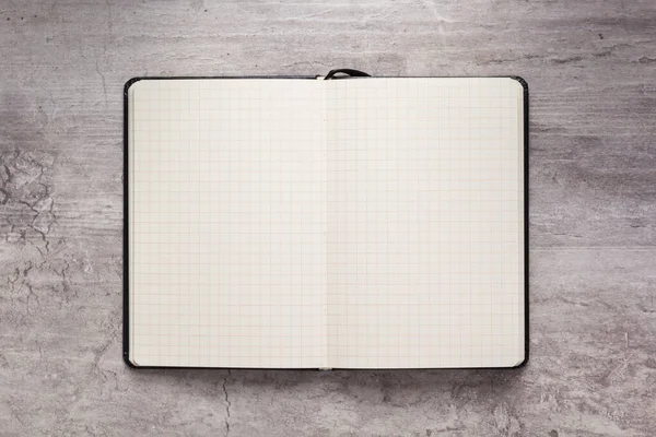 Papel de bloco de notas ou notebook no fundo de pedra — Fotografia de Stock
