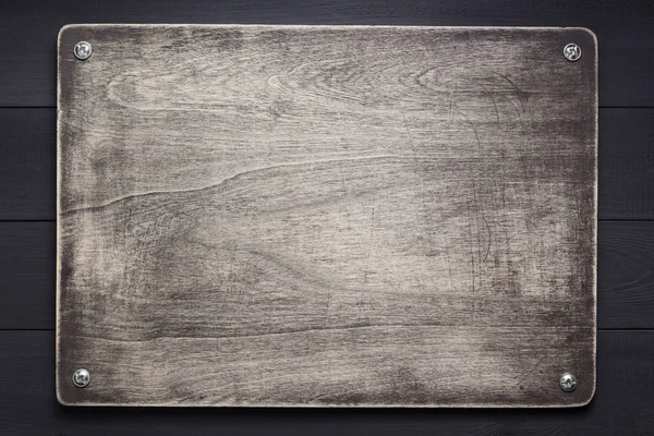 Plaque signalétique en bois à fond noir texture — Photo
