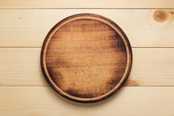 Pizza cutting board at rustic wooden plank background — Stock Photo, Image