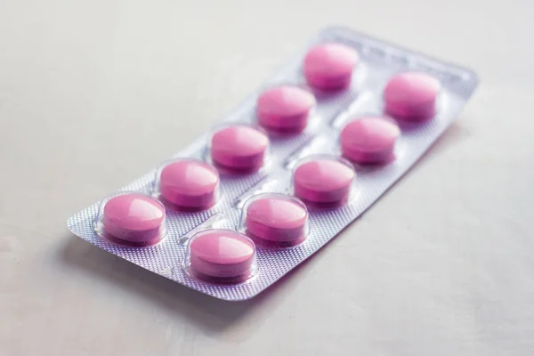 Blister with pills of pink color on a white background_ — 图库照片