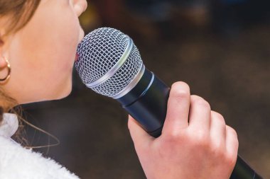 microphone in hand at the girl during the song_