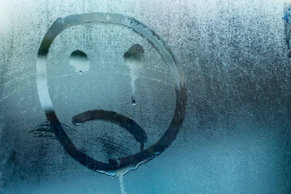  image of a crying face on a glass_