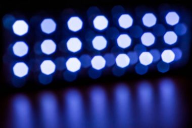 bright white fuzzy lights glow and shine on a dark background_