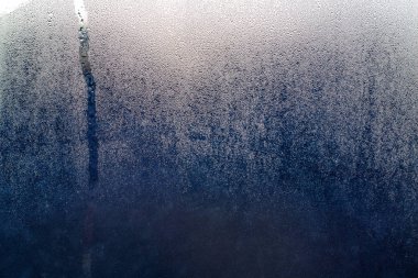 küçük cam arkasında koyu mavi cam üzerinde Su damlacıkları olduğunu 
