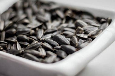 sunflower seeds lying in a plate can serve as a background_