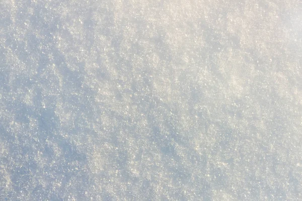 Textuur van wit met een blauwe tint van sneeuw, genomen op een zonnige winte — Stockfoto