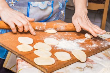woman preparing a festive meal from a dough, cooking at home_