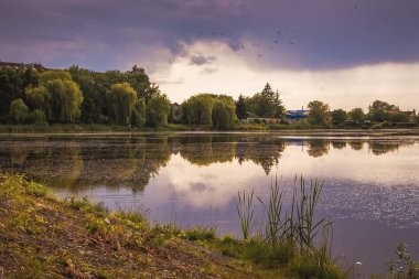 Dark stormy sky above  river. Summer Landscape_