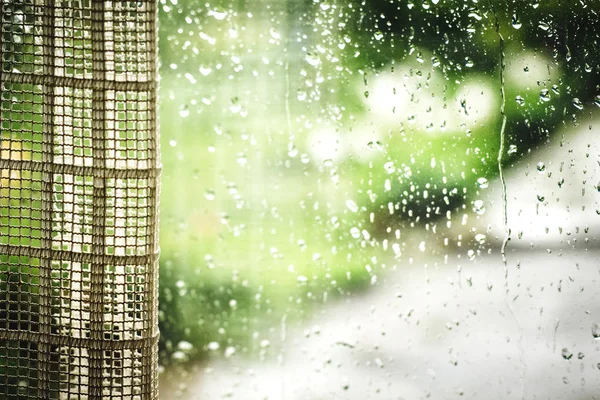 Vidro de janela molhado, coberto com cortina, durante a chuva. Montante chuvoso — Fotografia de Stock