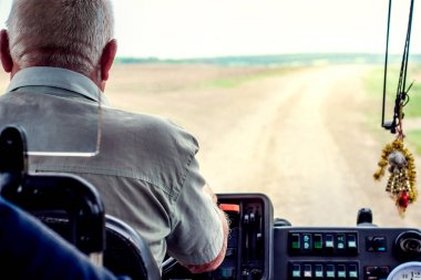 Bus driver behind  wheel. View of  road from  window of  bus_