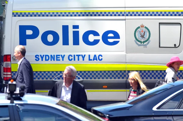Australian people pass by Sydney Police vehicle in Sydney New So