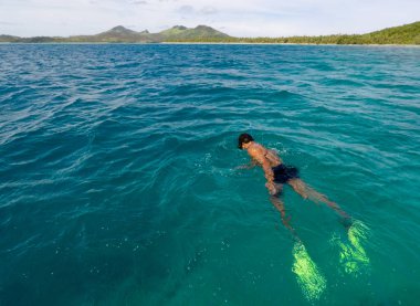 Fijian man snorkeling in Yasawa Island Fiji clipart