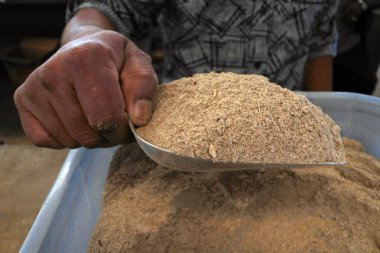 Man sale powder of the pepper plant root used to produce a Kava  clipart