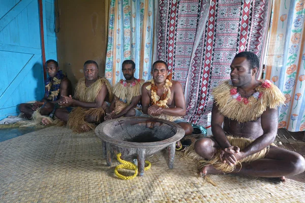 Indigenous Fijians men participate in traditional Kava Ceremony