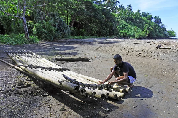 Indigenous Fijan man building a traditional Fijian bamboo boat — Stock Photo, Image