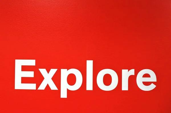 Explore word isolated on red background — Stock Photo, Image