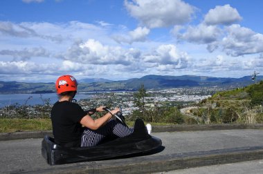 Woman ride on Skyline Rotorua Luge clipart