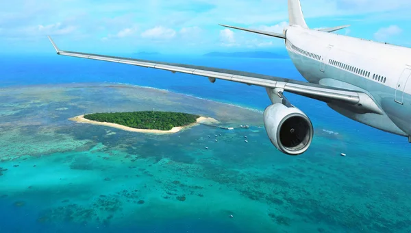 Avión de pasajeros vuela sobre la isla tropical — Foto de Stock