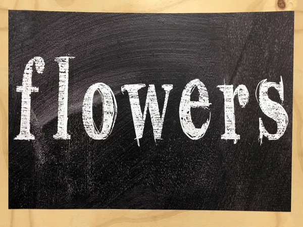 The word flowers written on a blackboard with wooden frame — Stock Photo, Image