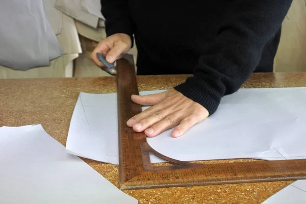 Hands of professional tailor chalking measurements — Stock Photo, Image