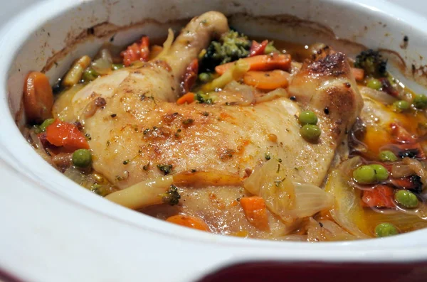 Chicken and vegetables slow cooking in a stoneware — Stock Photo, Image