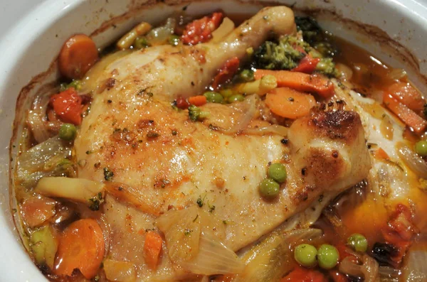 Chicken and vegetables slow cooking in a stoneware — Stock Photo, Image